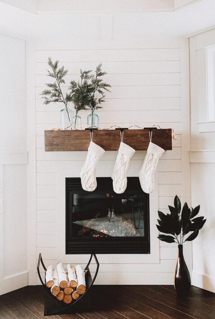 Holiday decor, stockings, around a fireplace.